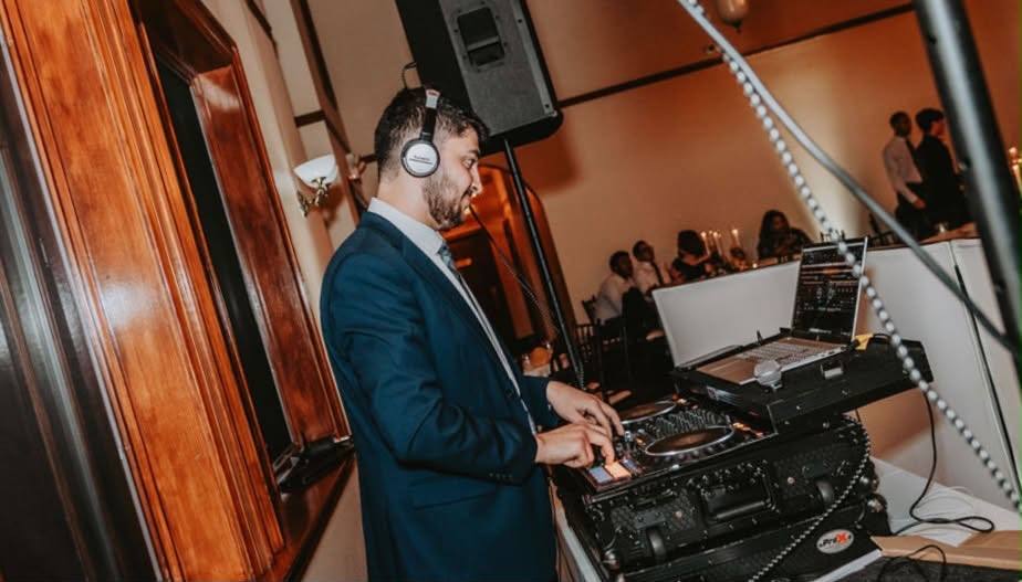 DJ Marc mixing live on the decks during a wedding reception