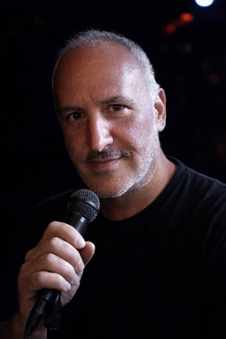 DJ Matthew Ostroff holding a microphone