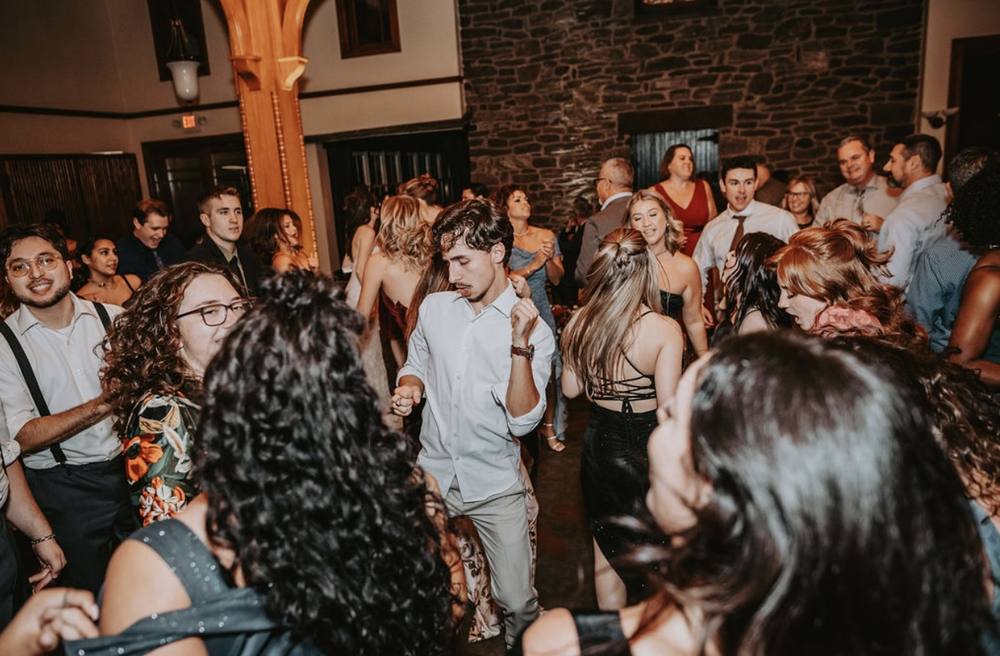 Guests dancing in a barn reception