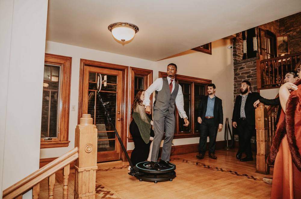 Guest posing on a 360 photo booth platform