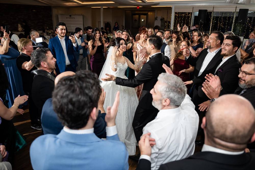 Wedding guests dancing in a crowded ballroom
