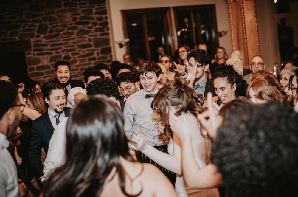 Guests singing together on the dance floor
