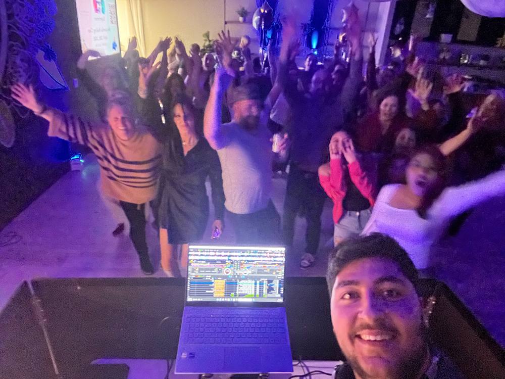 SpinVibe DJ taking a selfie with a packed dance floor at Insieme Event Venue