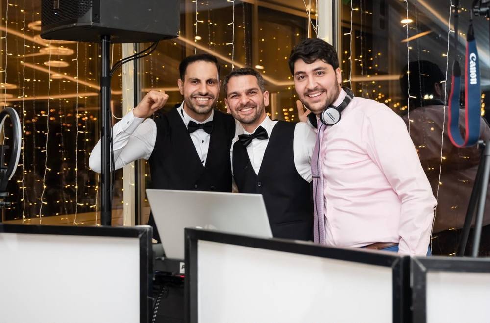 The SpinVibe DJ team behind the booth at Woodstone Country Club