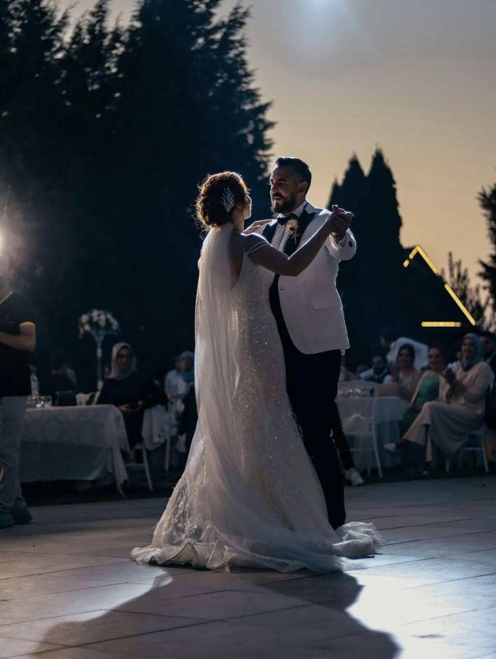Couple in a spotlight during their first dance at night