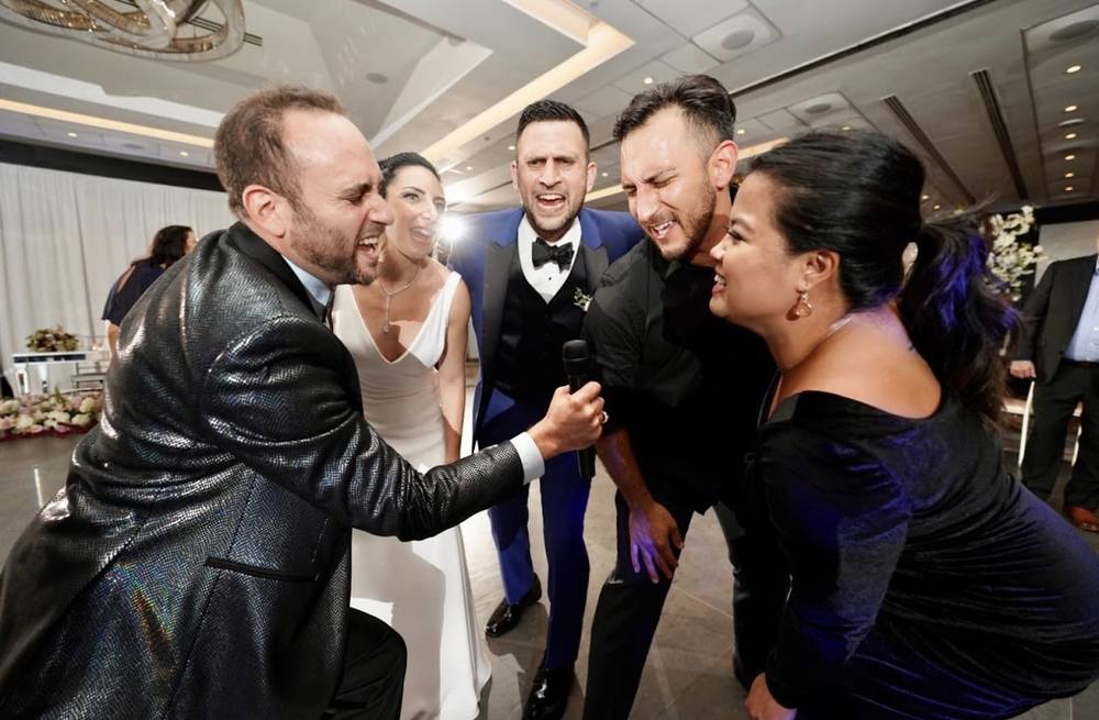 Groom dancing with guests