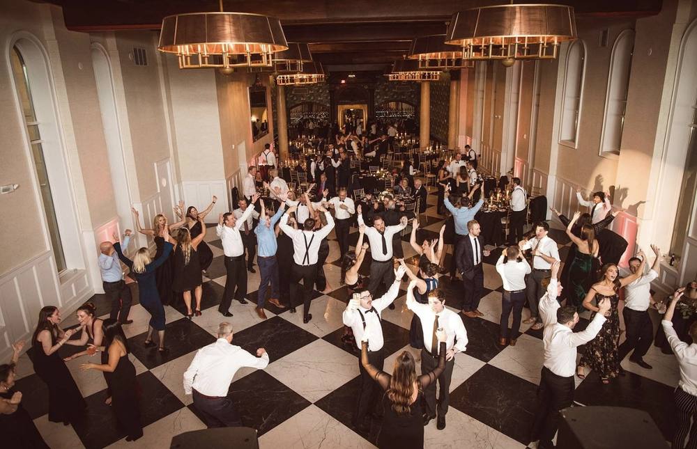 Packed ballroom dance floor on a checkered floor