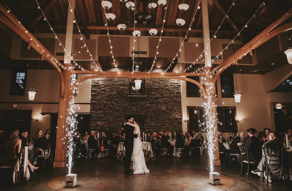Cold sparks along the dance floor of a rustic barn venue