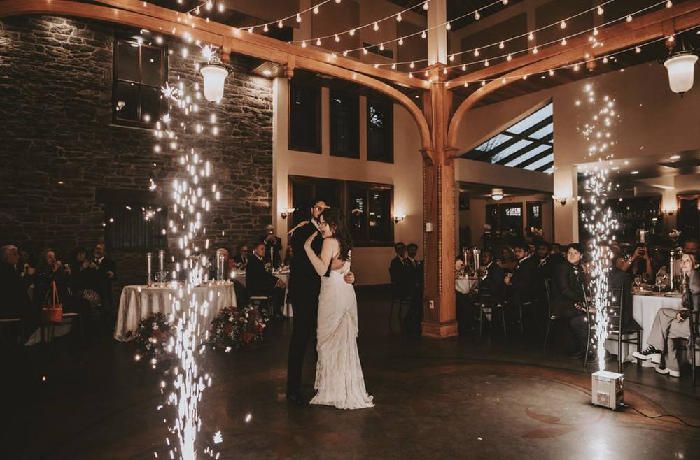 Cold sparks framing a first dance in a barn
