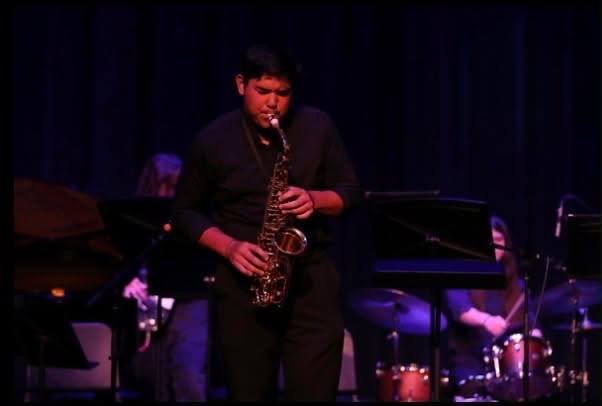 Ethan, SpinVibe's saxophonist, performing live on stage